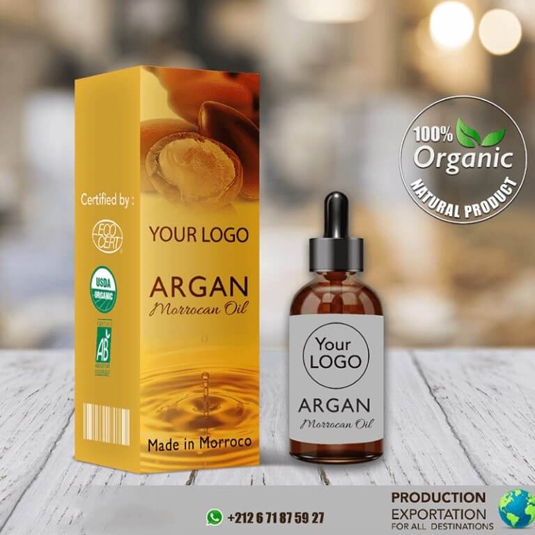 A bottle of Moroccan argan oil with customizable branding, placed next to its golden packaging labeled 'Your Logo' and featuring organic certification badges.